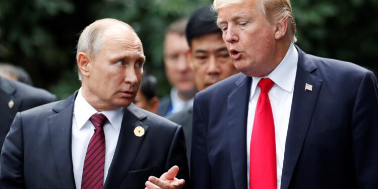U.S. President Donald Trump and Russia's President Vladimir Putin talk during the family photo session at the APEC Summit in Danang, Vietnam November 11, 2017. REUTERS/Jorge Silva - RC1B1EDB0E40